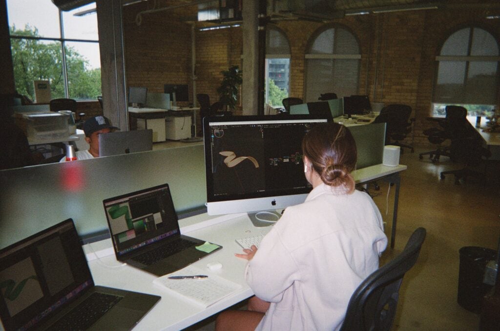 Miranda, BMD graphic designer working at her office desk