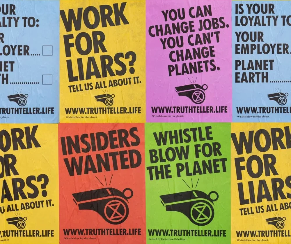 Two rows of various coloured posters highlighting the importance of being a whistle blower for the benefit of the earth