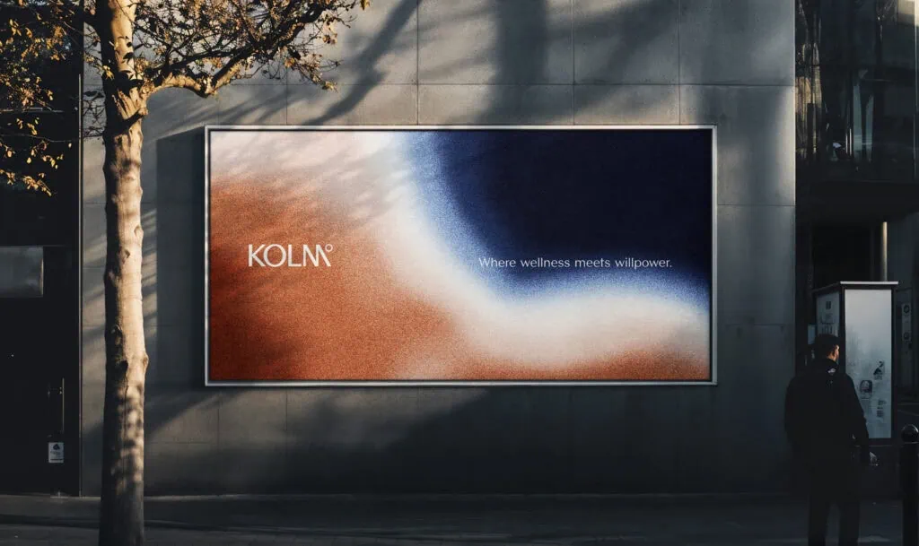 Kolm Kontrast Billboard on street with person walking by